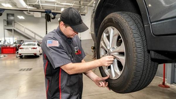 Stephen Wade Auto Technician Inspecting Car Wheel in St. George, UT