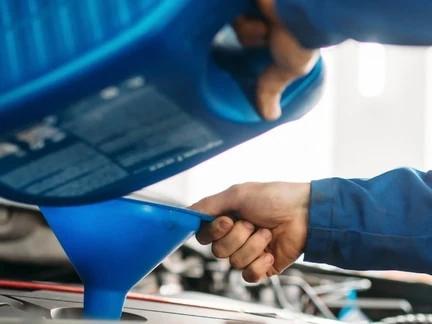 Auto Technician Pouring Oil Into Funnel in St. George, UT