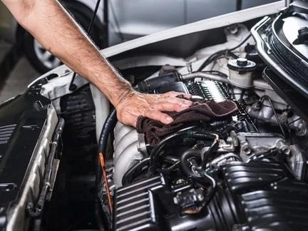 Auto Technician Wiping Engine With Rag in St. George, UT